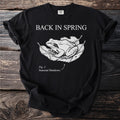 Black t-shirt with "BACK IN SPRING" and a frog on leaves, "Fig. 1: Seasonal Shutdown."