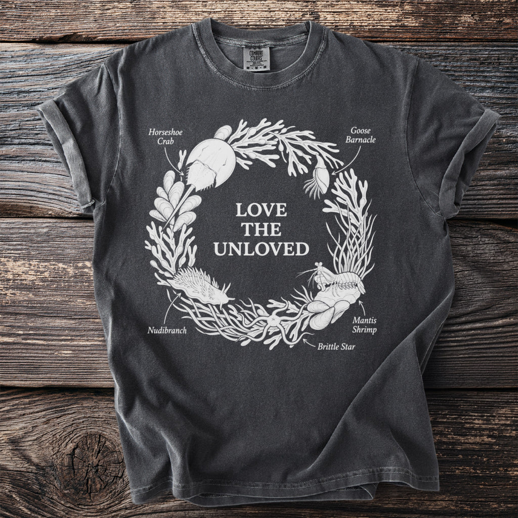 Dark grey t-shirt with "Love The Unloved" text and illustrated sea creatures.