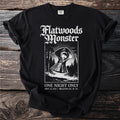 Black t-shirt with "Flatwoods Monster" graphic and event details.