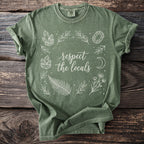 Green t-shirt with "respect the locals" text and crystals, leaves, moon and flowers design.