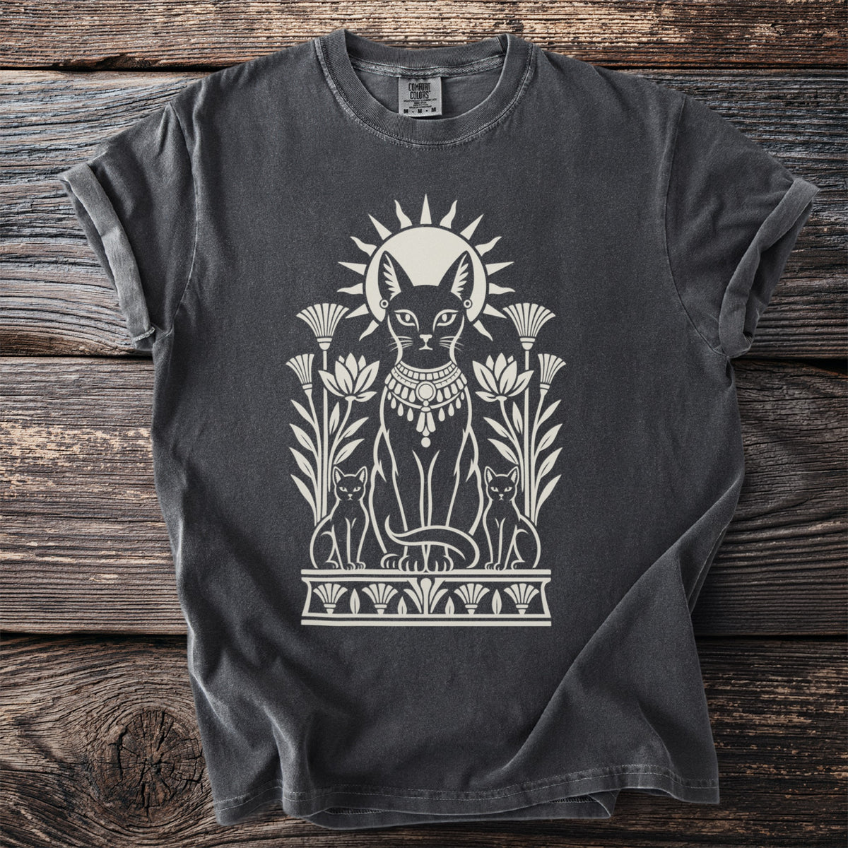 Dark t-shirt with Egyptian cat design and sun symbol.