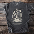 Dark t-shirt with white botanical illustration of orchids and text "The Sunken Garden Bog Orchid Plate III".