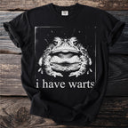 Black t-shirt with a close-up vintage-style graphic of a toad and text "i have warts."