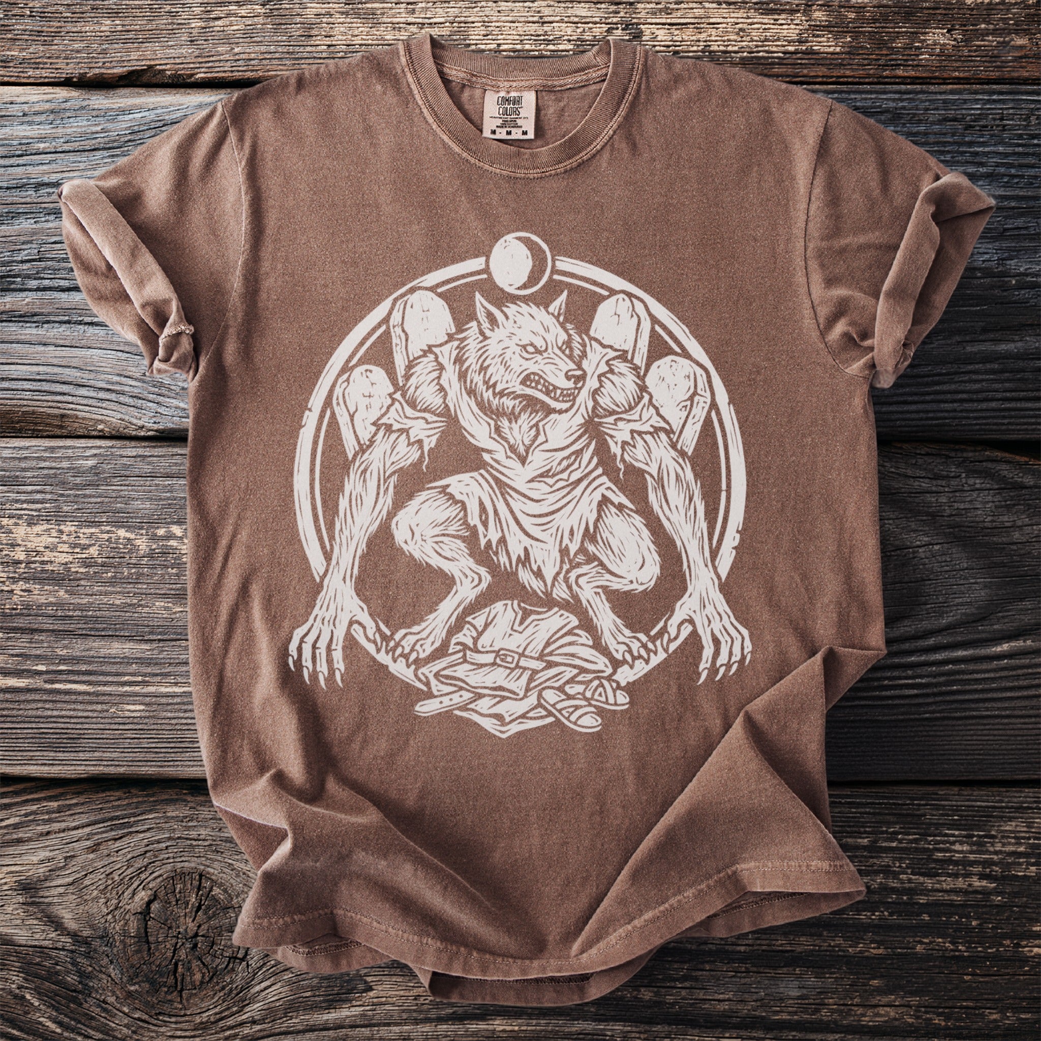 Brown t-shirt with a white graphic of a werewolf within a circular frame.