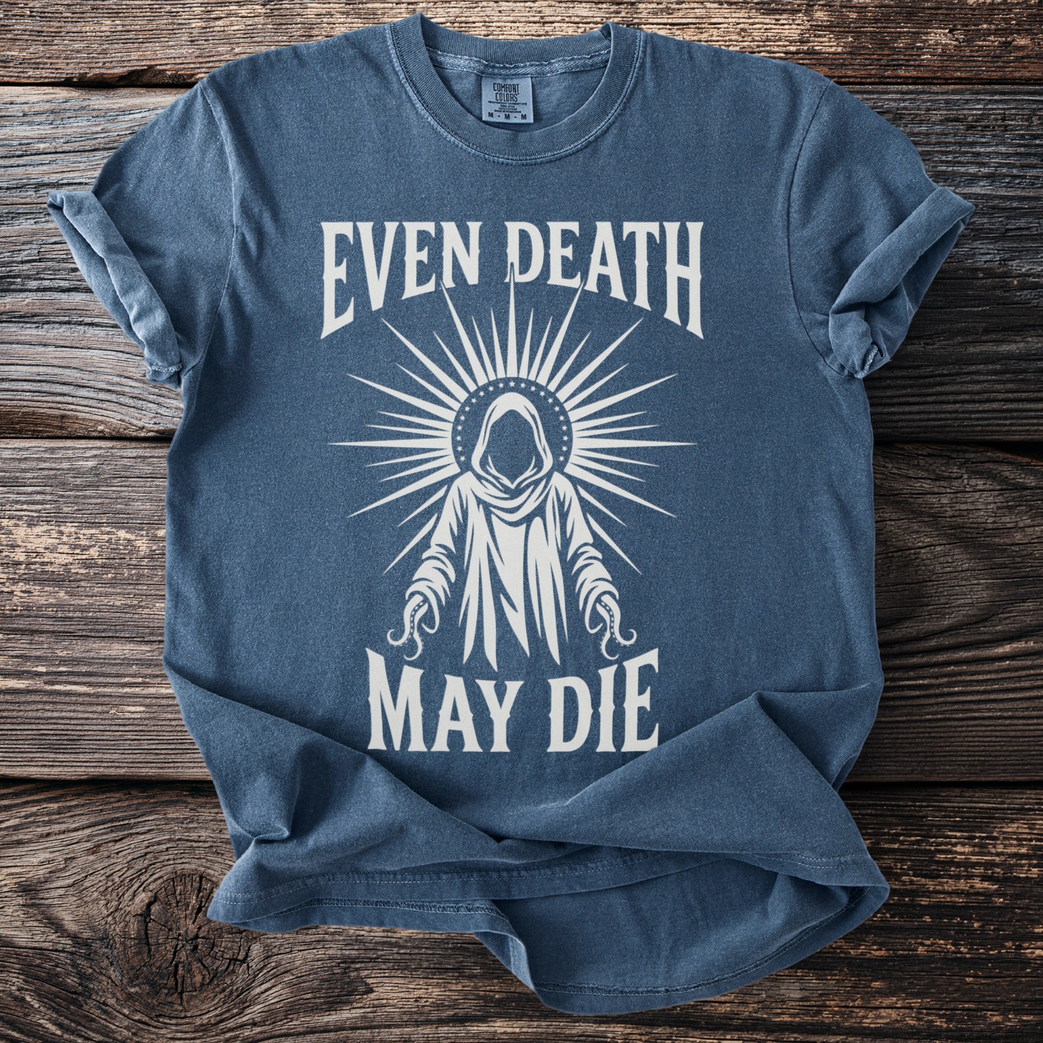 Blue t-shirt with graphic and text reading "Even Death May Die".