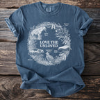 Blue t-shirt with white line art of "Love The Unloved" animals in a wreath.