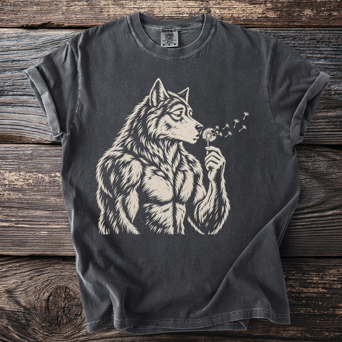 Werewolf blowing dandelions on a dark grey t-shirt with Comfort Colors label.