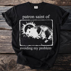 Black t-shirt with "patron saint of avoiding my problem" and a hamster graphic.