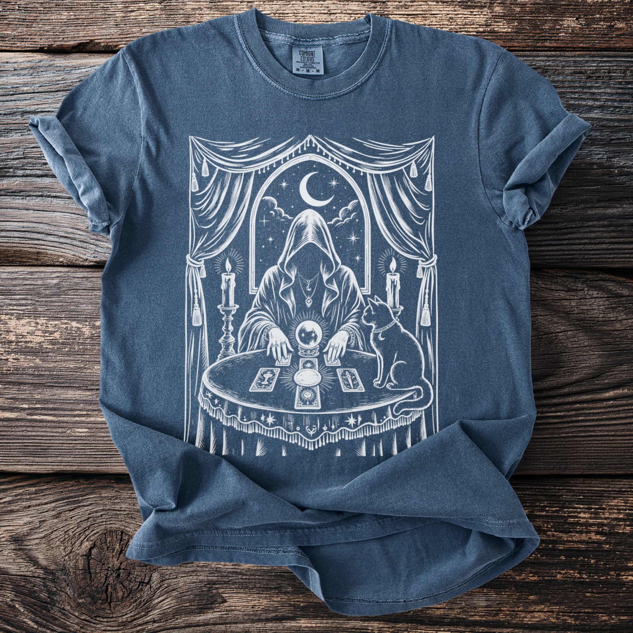 Dark blue t-shirt with mystical fortune teller, crystal ball, tarot cards, and cat design.
