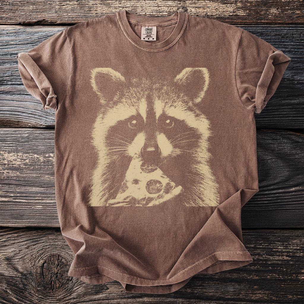 Brown t-shirt with a graphic of a raccoon eating pizza.