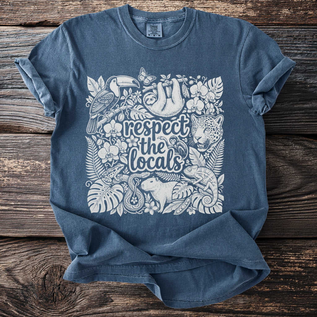 Blue t-shirt with white line art of jungle animals and text "respect the locals".