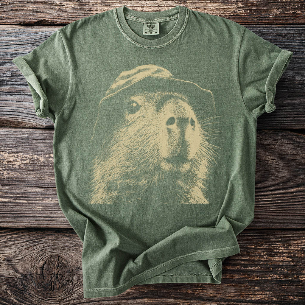 Green t-shirt with a vintage stencil graphic of a capybara wearing a hat.