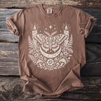 Brown t-shirt with white moth, moon, candles, mushrooms, and stars graphic.