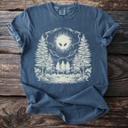Blue t-shirt with cream graphic of an alien head over a forest scene.