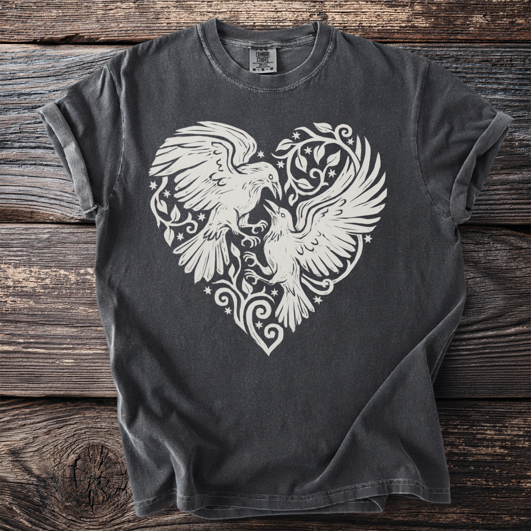 Dark gray t-shirt with white graphic of two birds facing each other within a heart shape.
