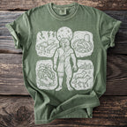 Green t-shirt with a linocut print of a werewolf and surrounding vignettes.