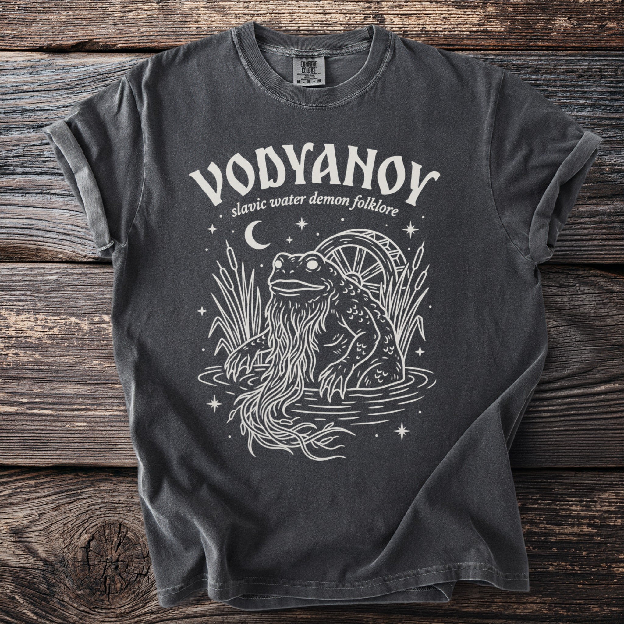 Dark grey t-shirt with white graphic of a frog-like creature with long beard and a water wheel.