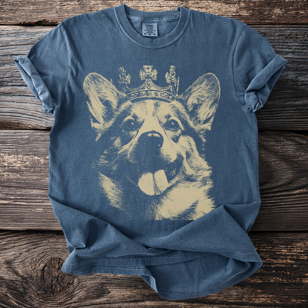 Blue t-shirt with a beige graphic of a corgi wearing a crown.