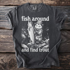 Dark t-shirt graphic with opossum holding large trout and text "fish around and find trout."