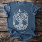 Blue t-shirt with a white graphic of a tree, two ravens, moon, and runes.