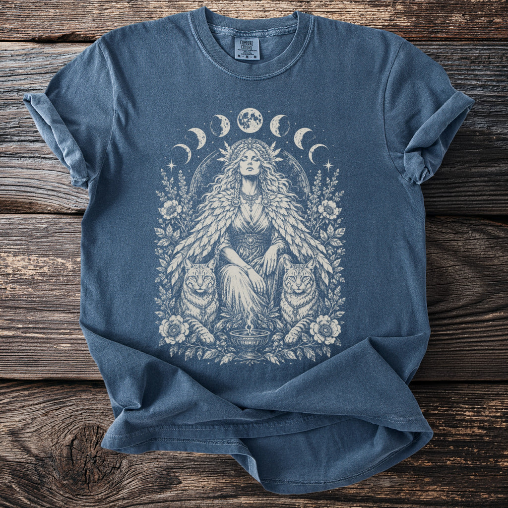 Blue t-shirt with a moon phases circle and a female figure flanked by two lynxes.