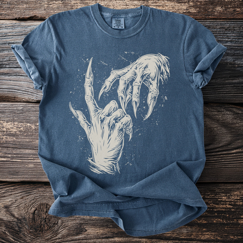 Blue t-shirt with illustration of two monster hands reaching towards each other.