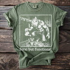 Green t-shirt with a werewolf watering a plant, text "feral but functional".