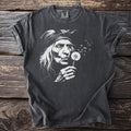 Dark gray t-shirt with graphic of an elder woman blowing a dandelion.
