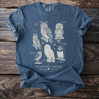 Blue t-shirt with an illustrated study of six owls titled "The Wisdom Cabinet" and "An Illustrated Ornithology of Owls".