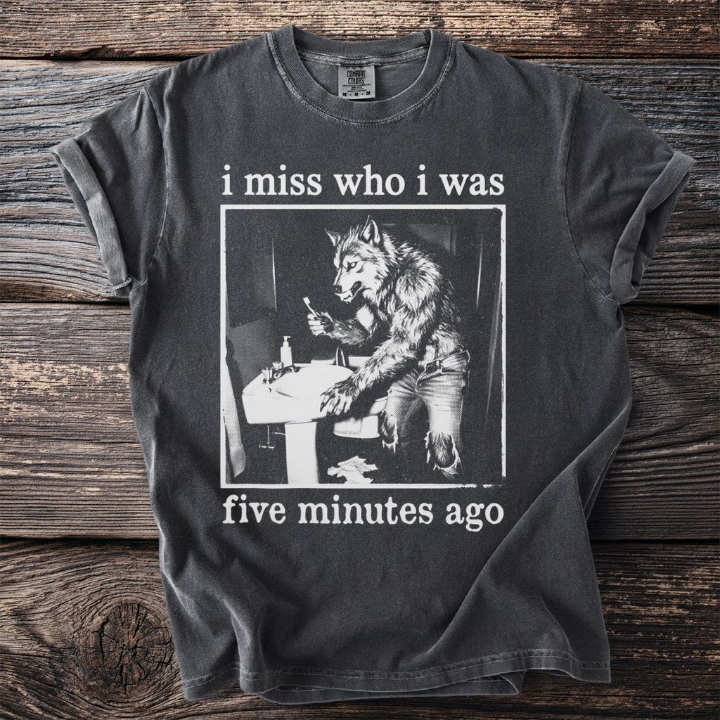 Dark grey t-shirt with white text "i miss who i was" and a werewolf brushing teeth.