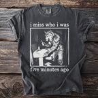 Dark grey t-shirt with white text "i miss who i was" and a werewolf brushing teeth.