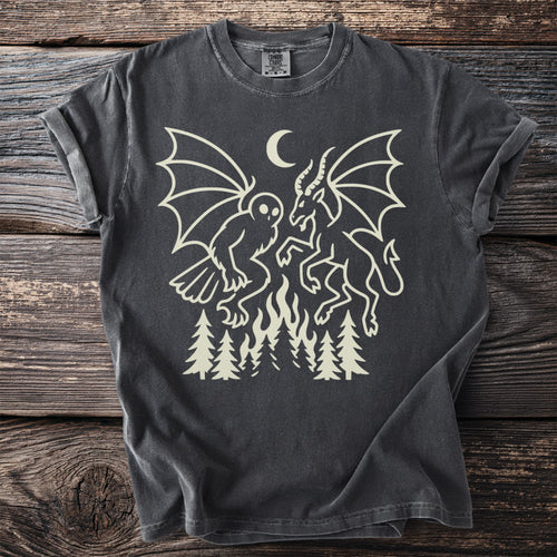 Dark gray t-shirt with cream graphic of mythical creatures, moon, fire, and trees.
