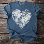 Blue t-shirt with white graphic of two birds in a heart shape on a wooden surface.