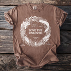 Brown t-shirt with "Love the Unloved" and illustrations of aquatic creatures.