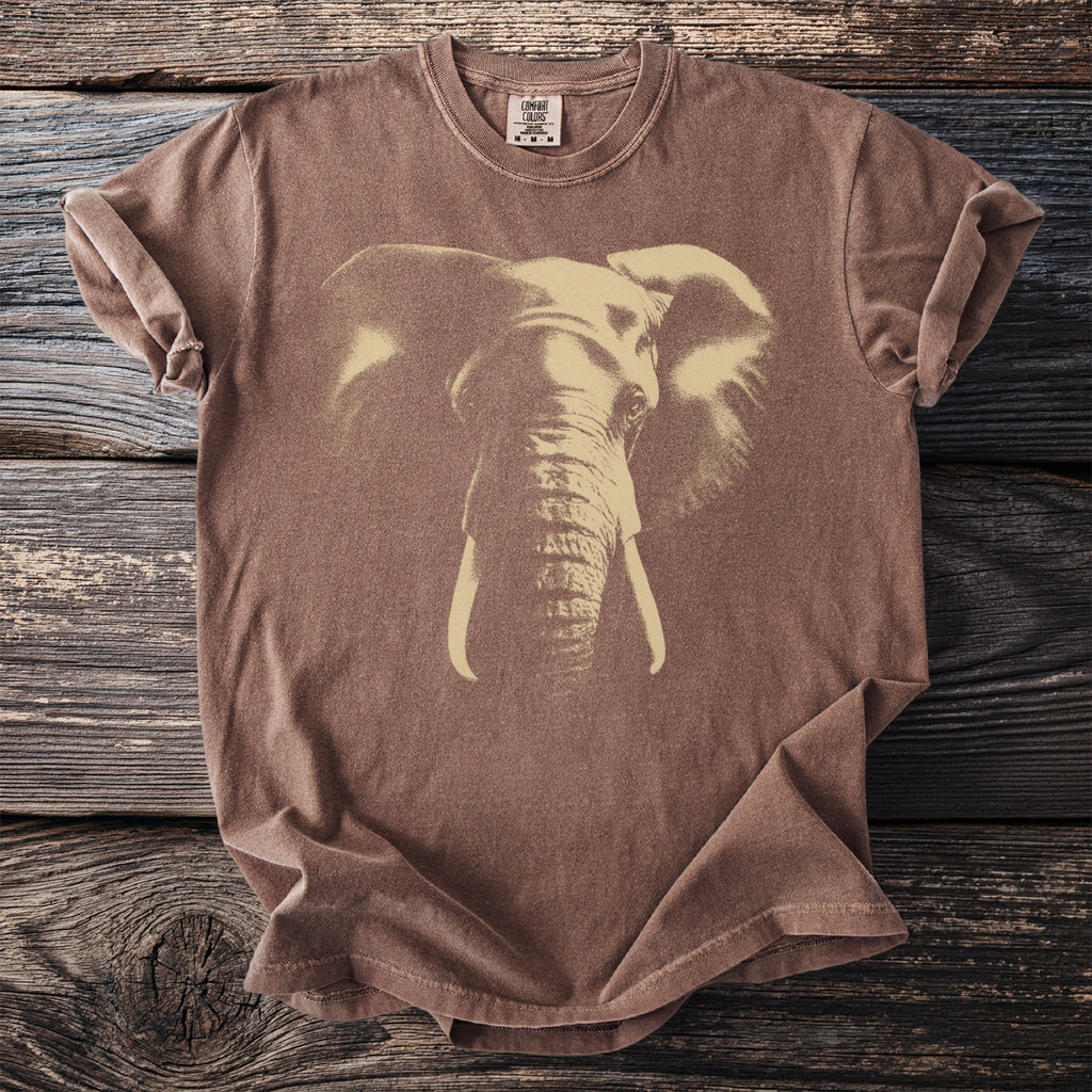 Brown t-shirt with a light beige elephant graphic and "COMFORT COLORS" tag.