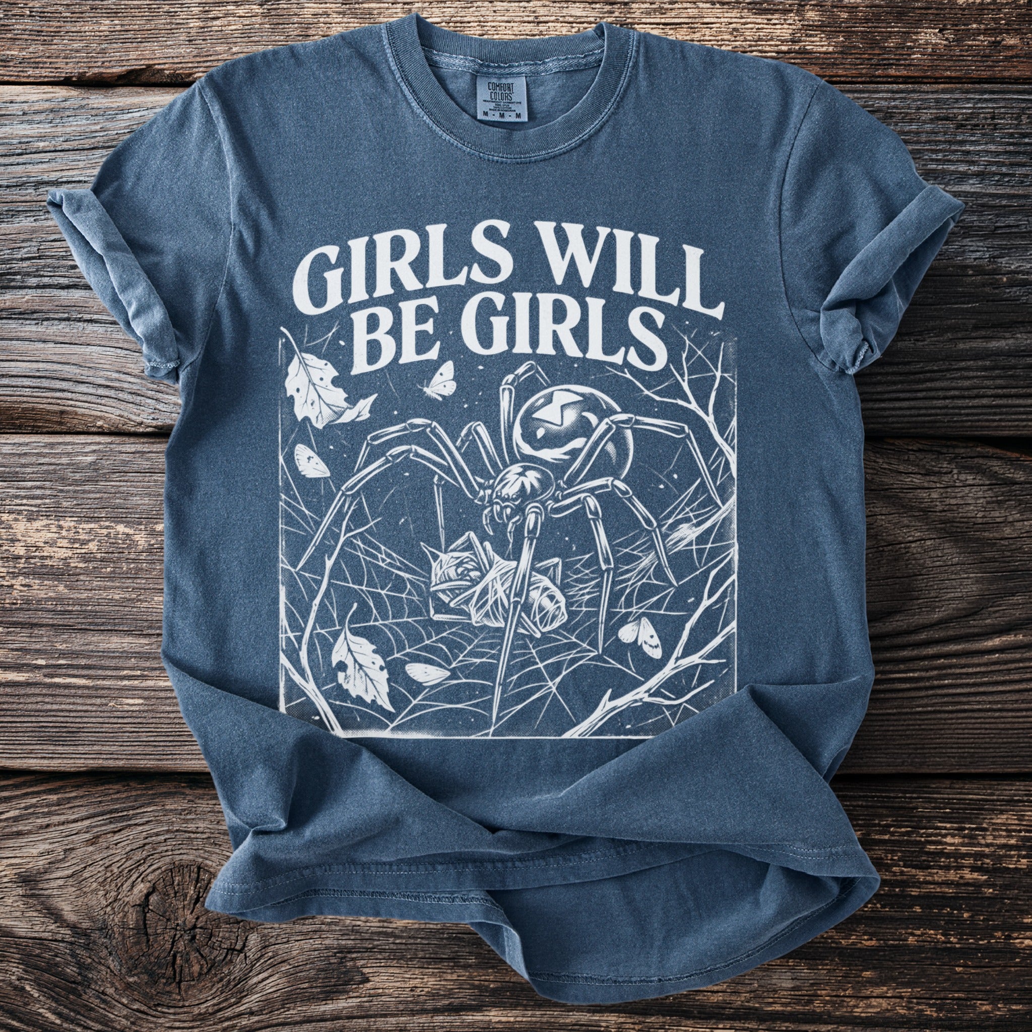 Blue t-shirt with white graphic of spider and text "GIRLS WILL BE GIRLS".
