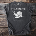 Dark gray t-shirt with white text "IN A MINUTE" and a drawing of a snail.