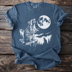 Raccoon howling at the moon with another raccoon in the background.