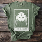 Opossum graphic on a green t-shirt with "the menace" text.