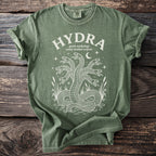 Green t-shirt with white print of the word HYDRA and a multi-headed serpent.