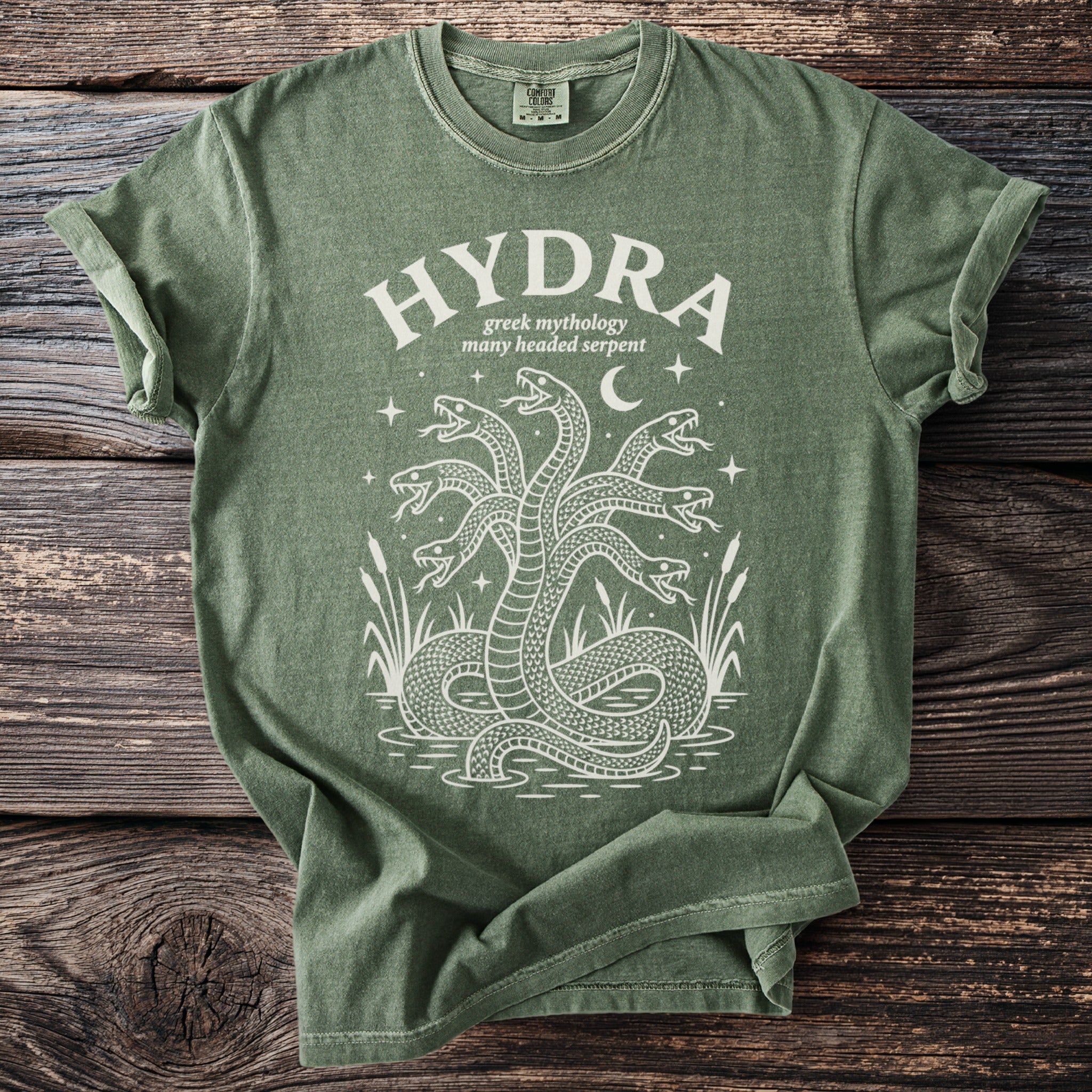 Green t-shirt with white print of the word HYDRA and a multi-headed serpent.