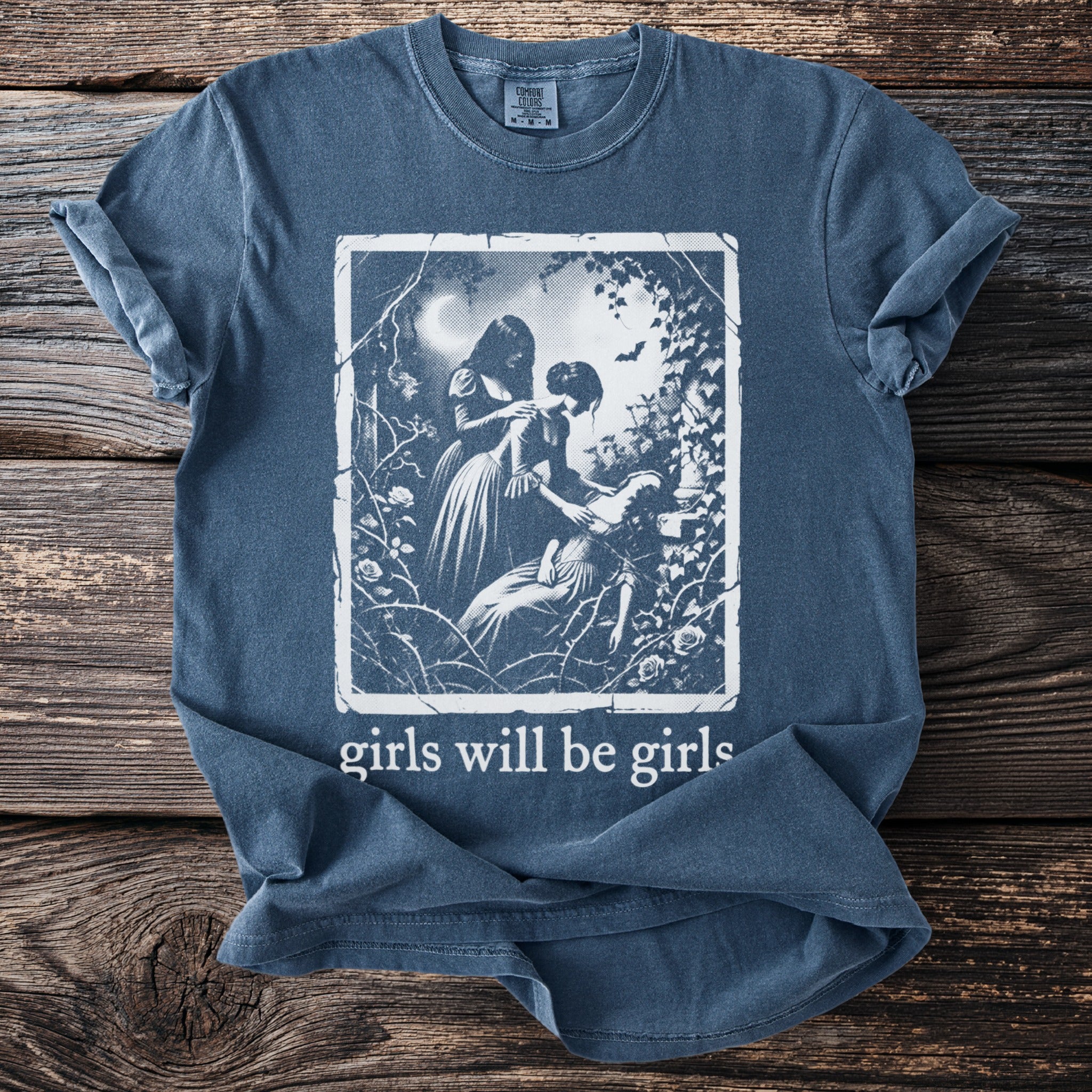 Blue t-shirt with "girls will be girls" text and a vintage illustration.