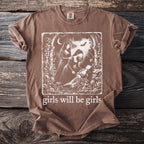 Brown t-shirt with graphic of three women and the text "girls will be girls".