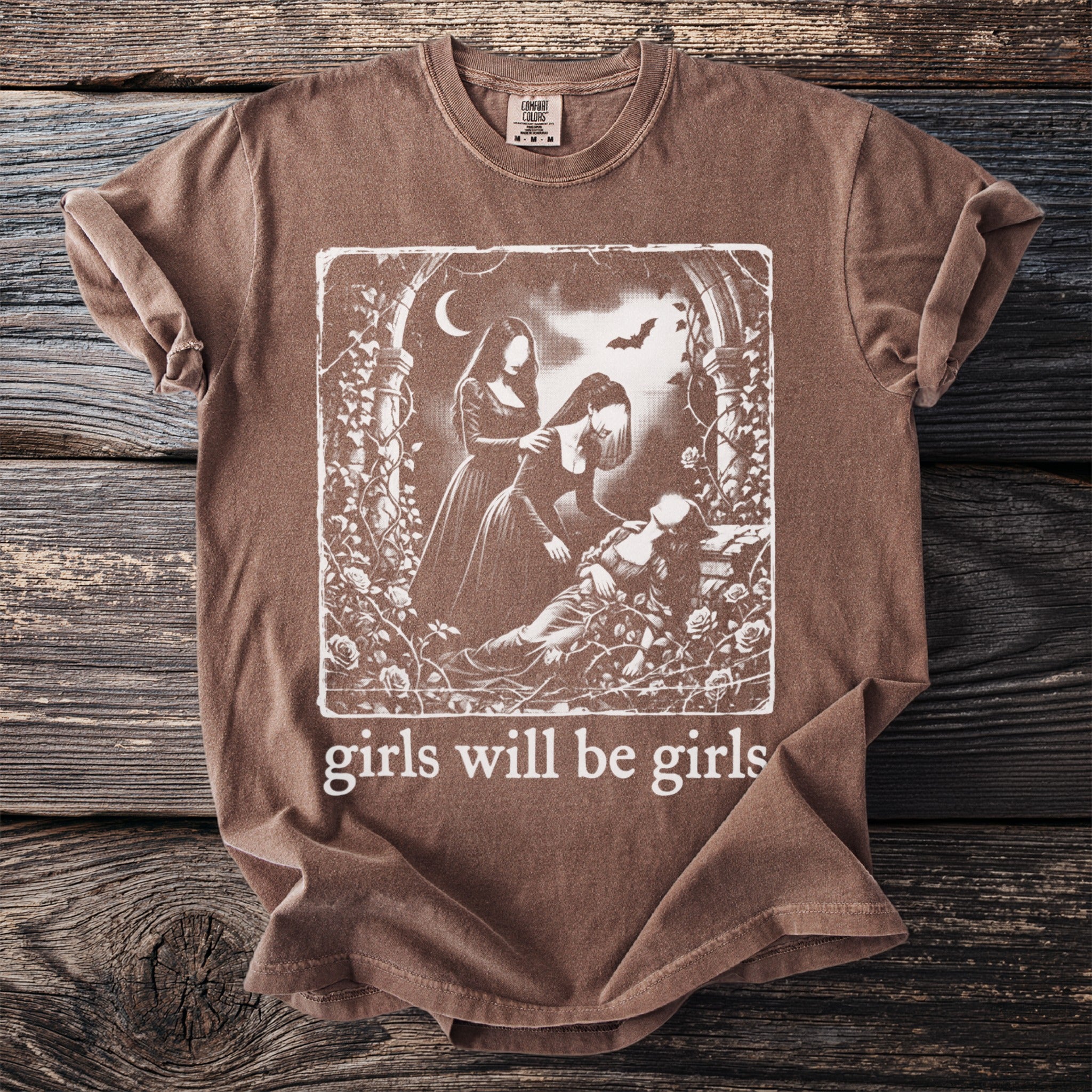 Brown t-shirt with graphic of three women and the text "girls will be girls".