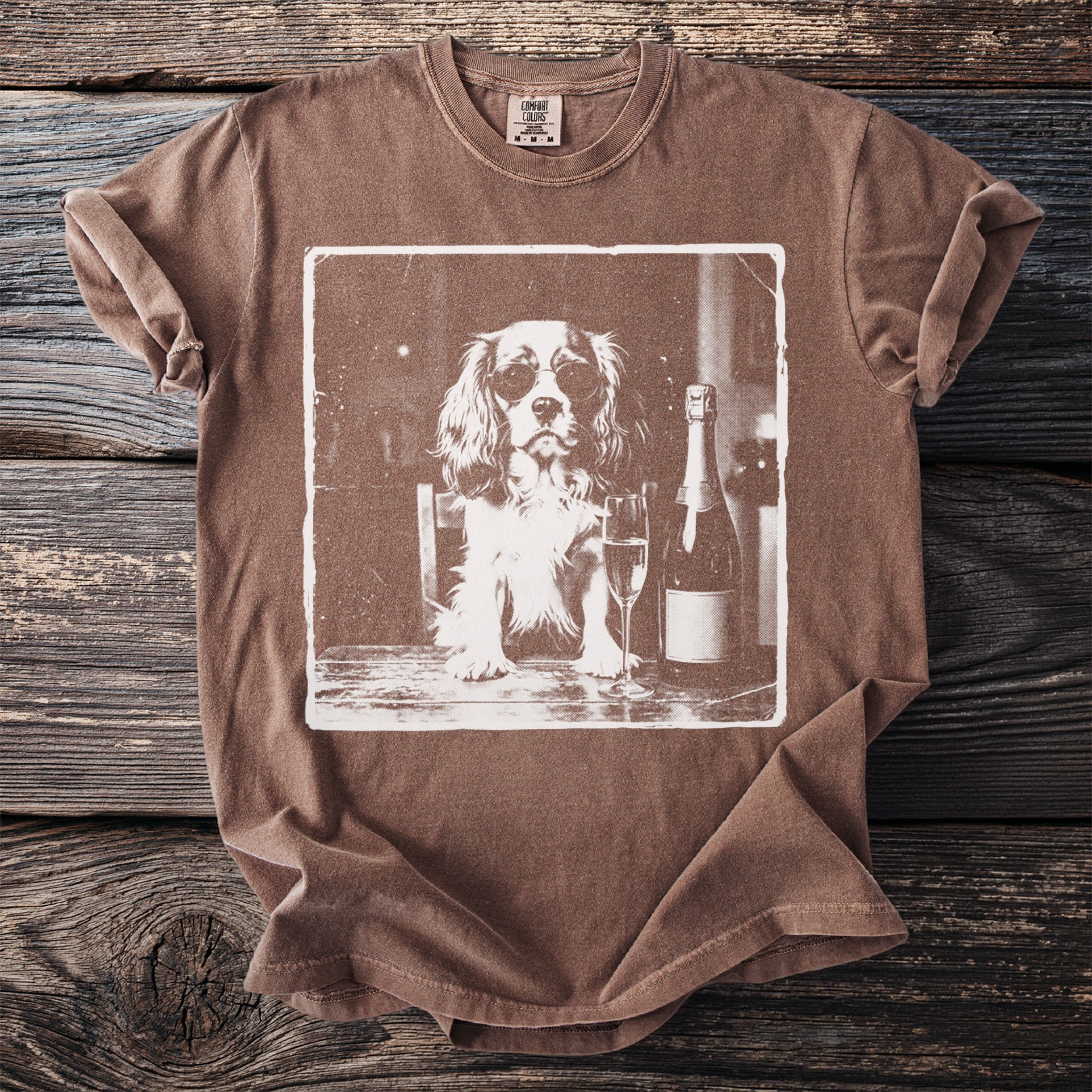 Brown t-shirt with a graphic of a dog wearing sunglasses and a champagne bottle.