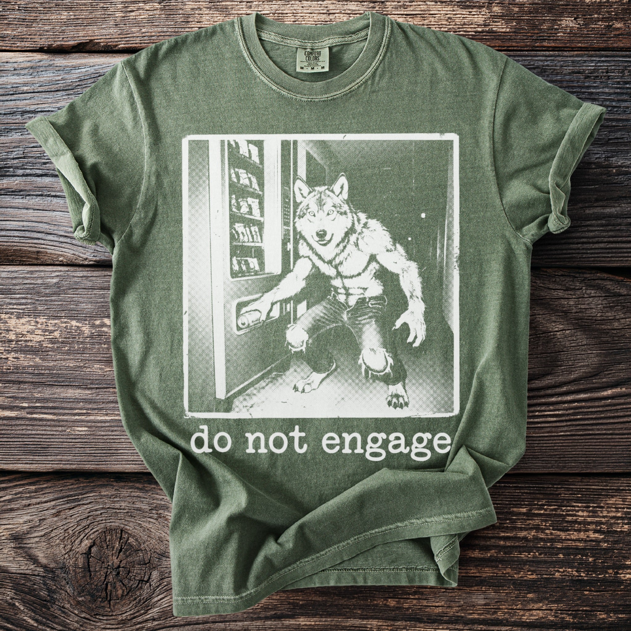 Olive green t-shirt with werewolf and vending machine graphic, saying "do not engage".