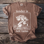 Brown t-shirt with "tender is not tame" and a wolf with a rabbit graphic.