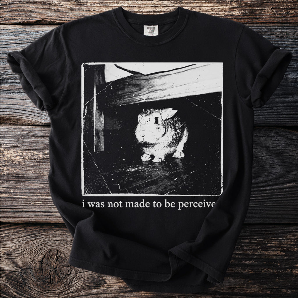Black t-shirt with a distressed graphic of a rabbit and text reading "i was not made to be perceive".