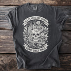 Dark t-shirt with skull, snake, plants, and text "ALL PLANTS ARE EDIBLE SOME ONLY ONCE".