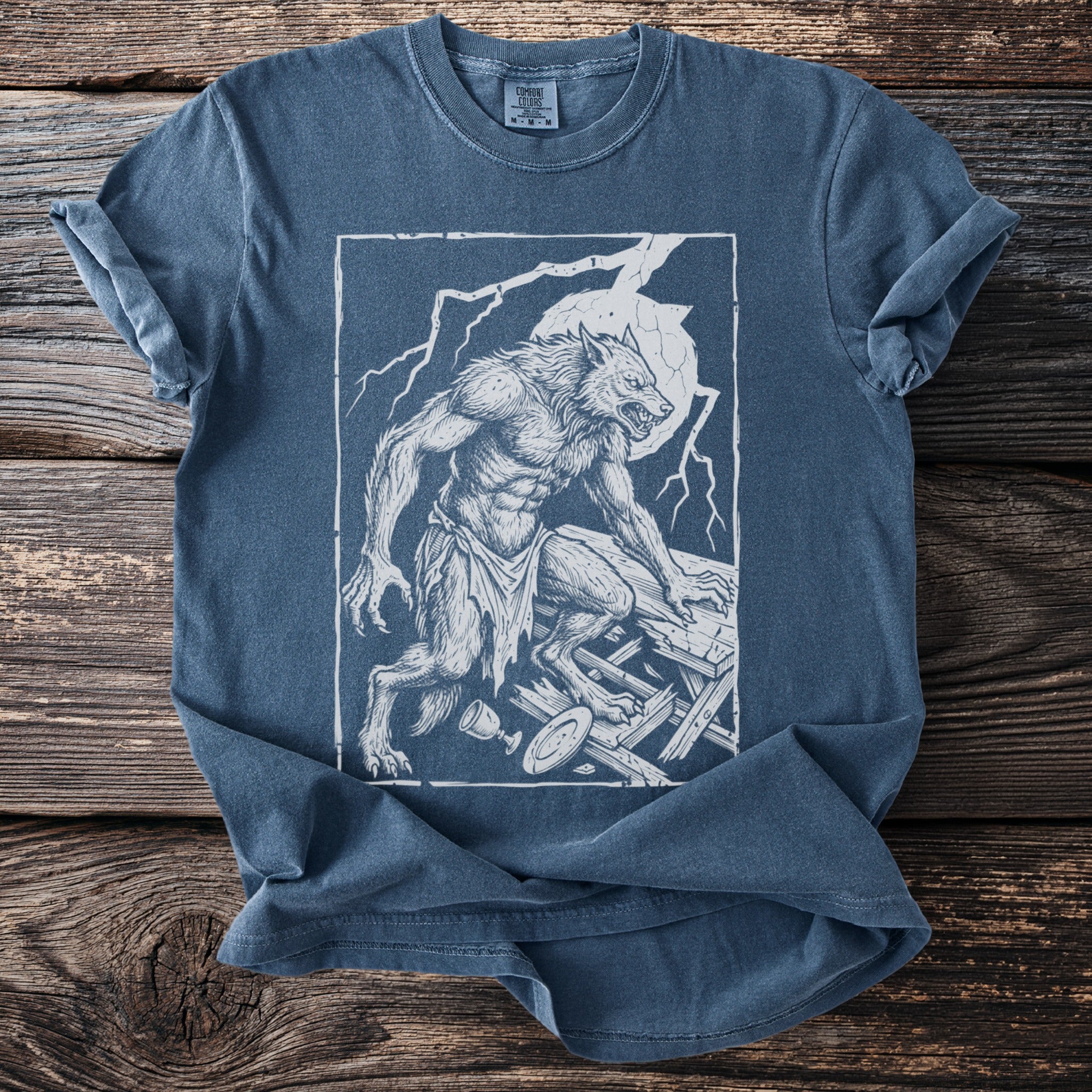 T-shirt with a white line drawing of a werewolf under a full moon and lightning.